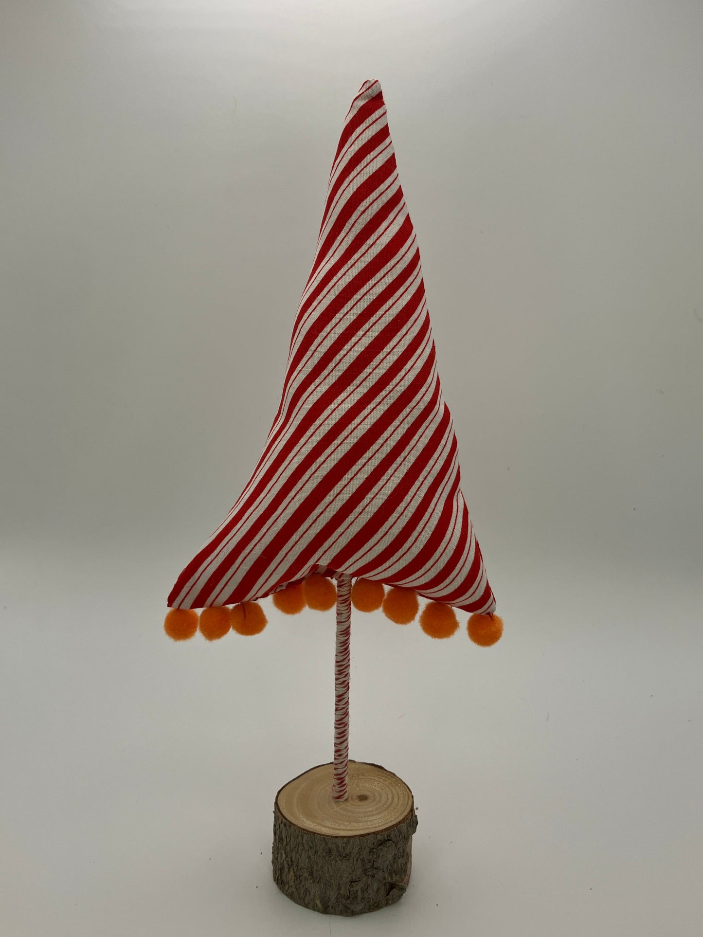 Red and white striped tree with orange pompoms