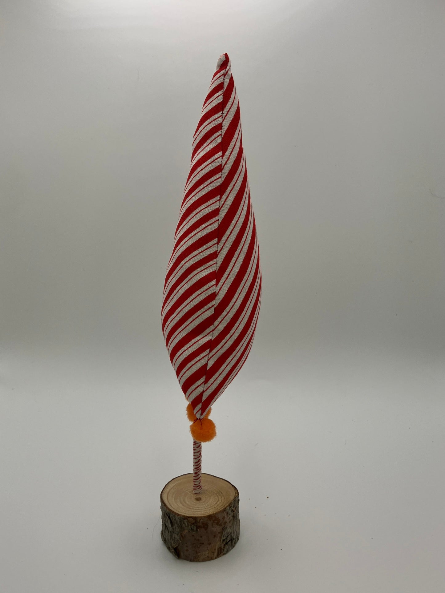 Red and white striped tree with orange pompoms