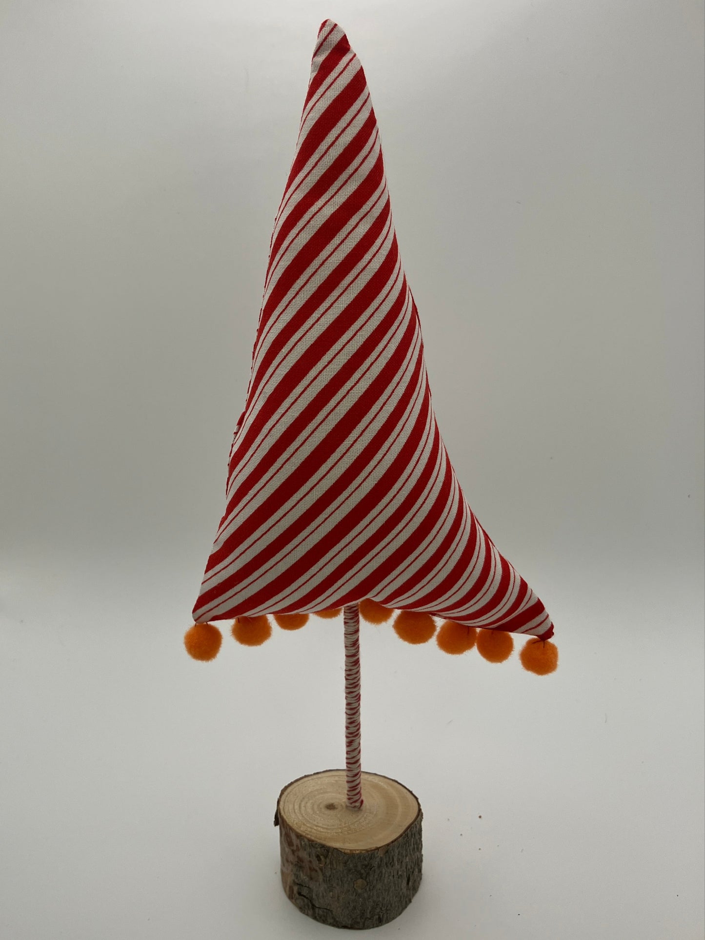 Red and white striped tree with orange pompoms