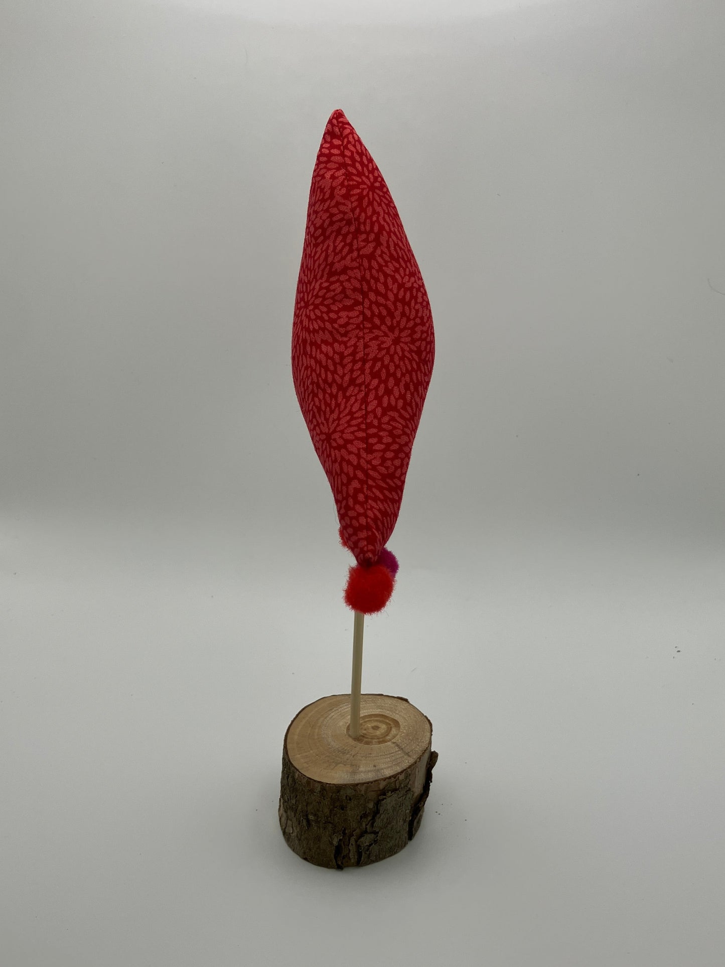 Red pattern fabric tree with pink and red pompoms.