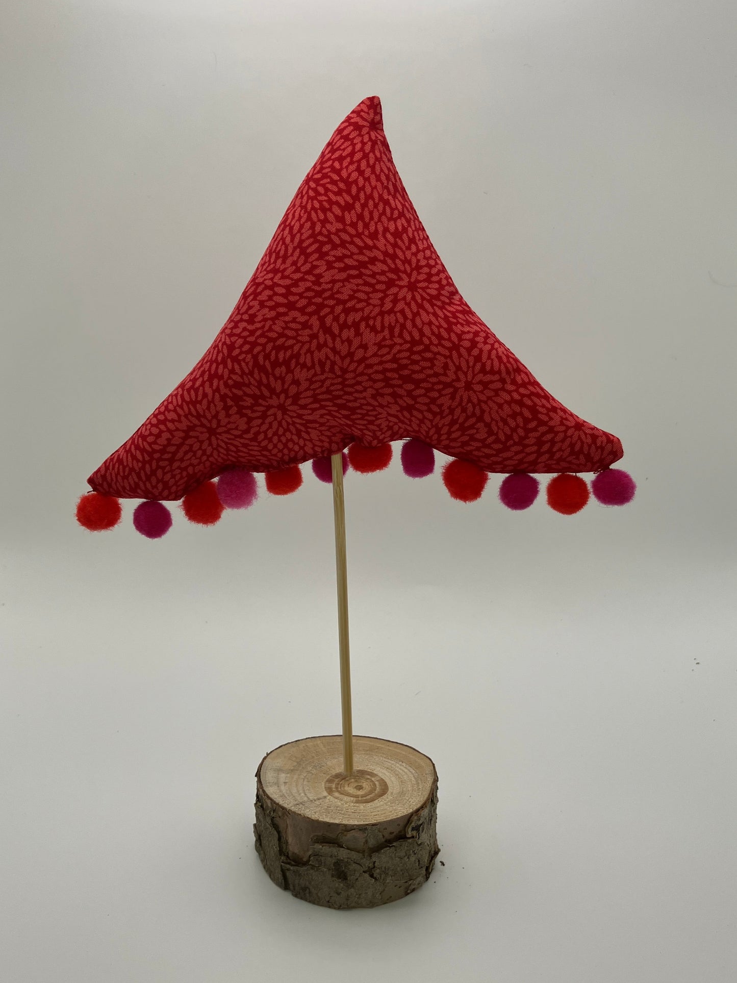 Red pattern fabric tree with pink and red pompoms.