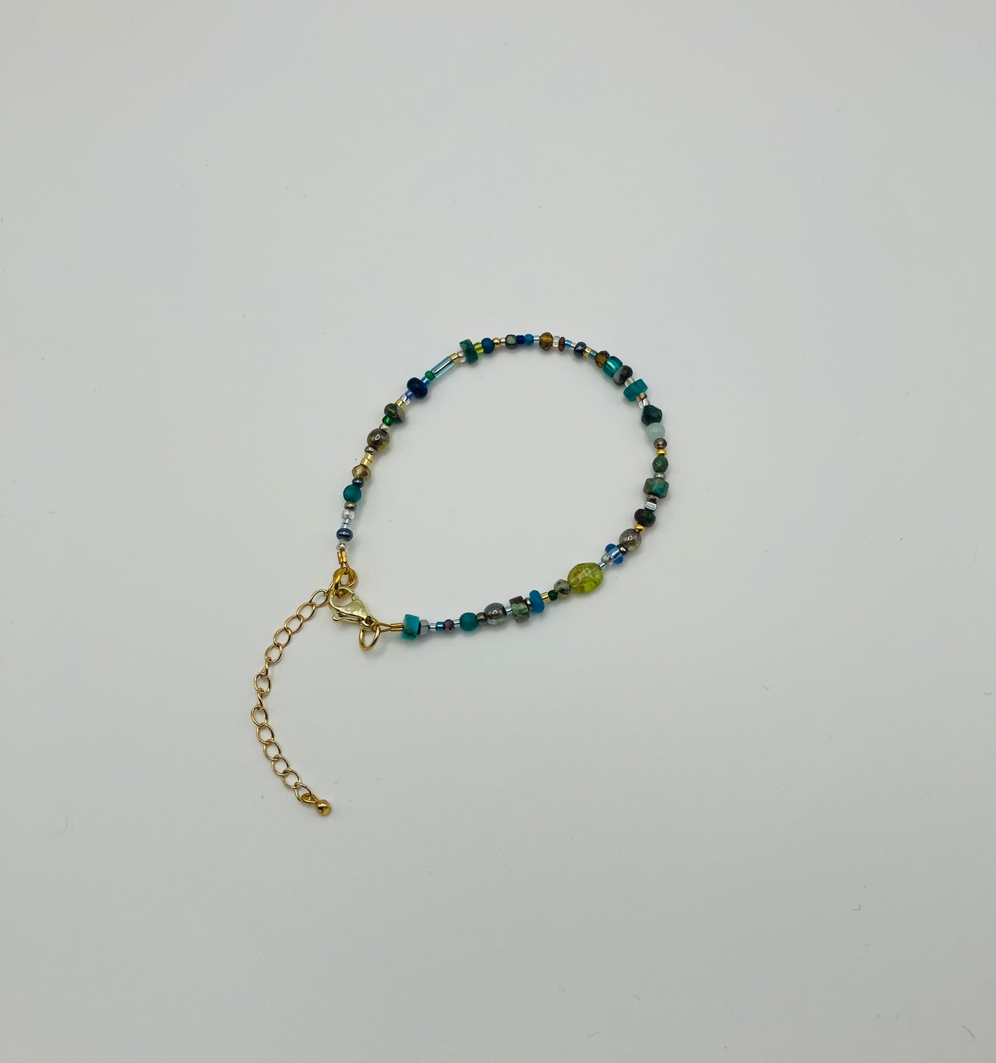Green and gold beaded bracelet with lobster clasp