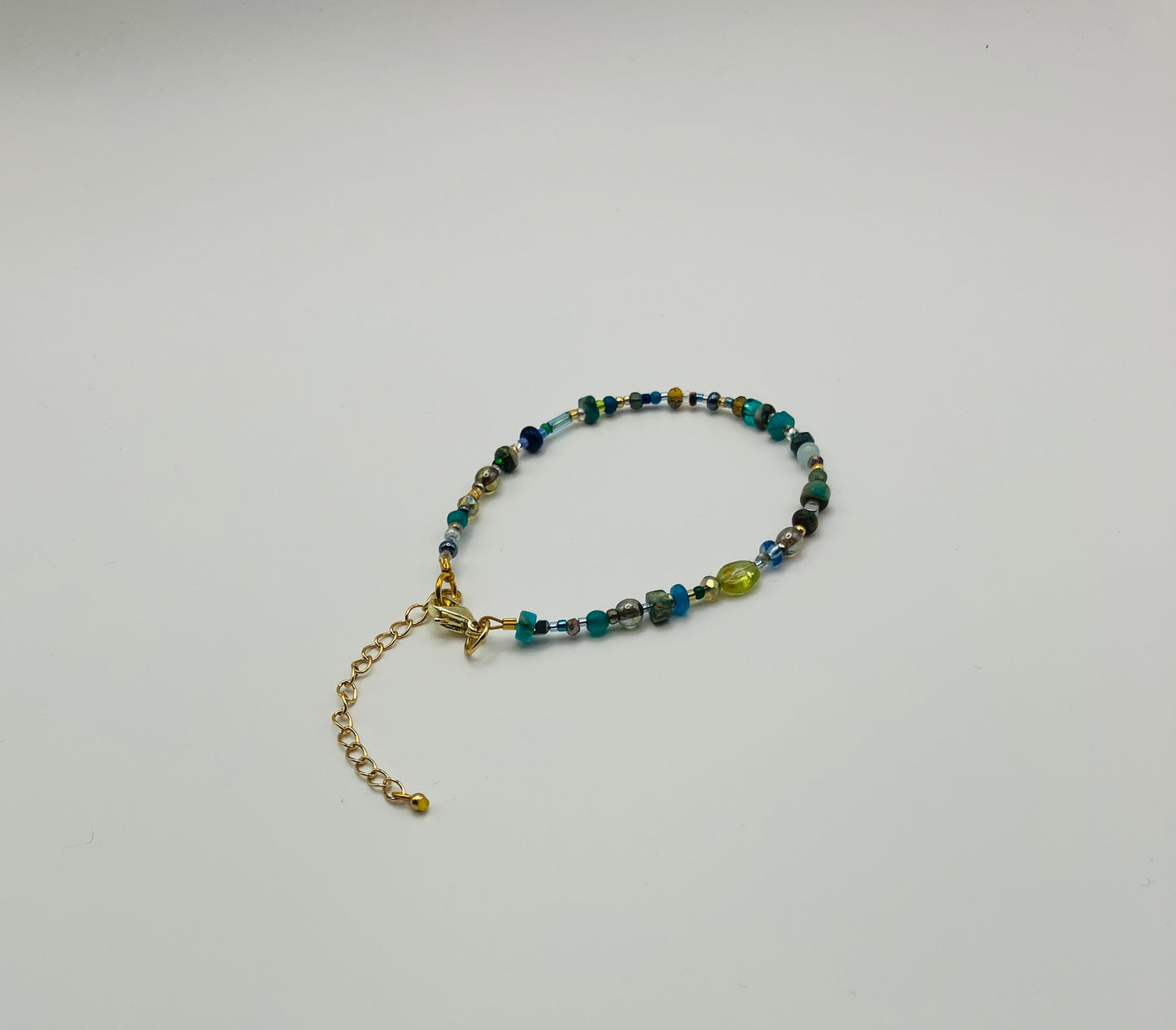 Green and gold beaded bracelet with lobster clasp