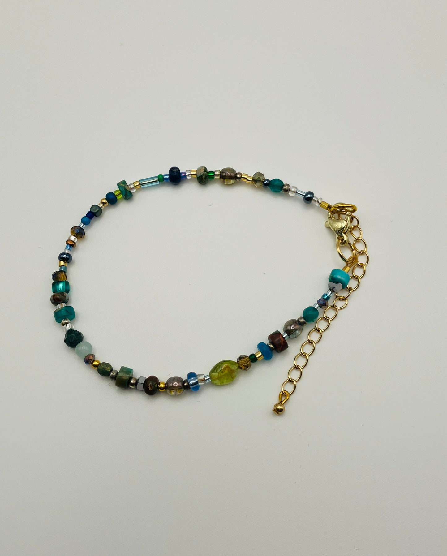 Green and gold beaded bracelet with lobster clasp