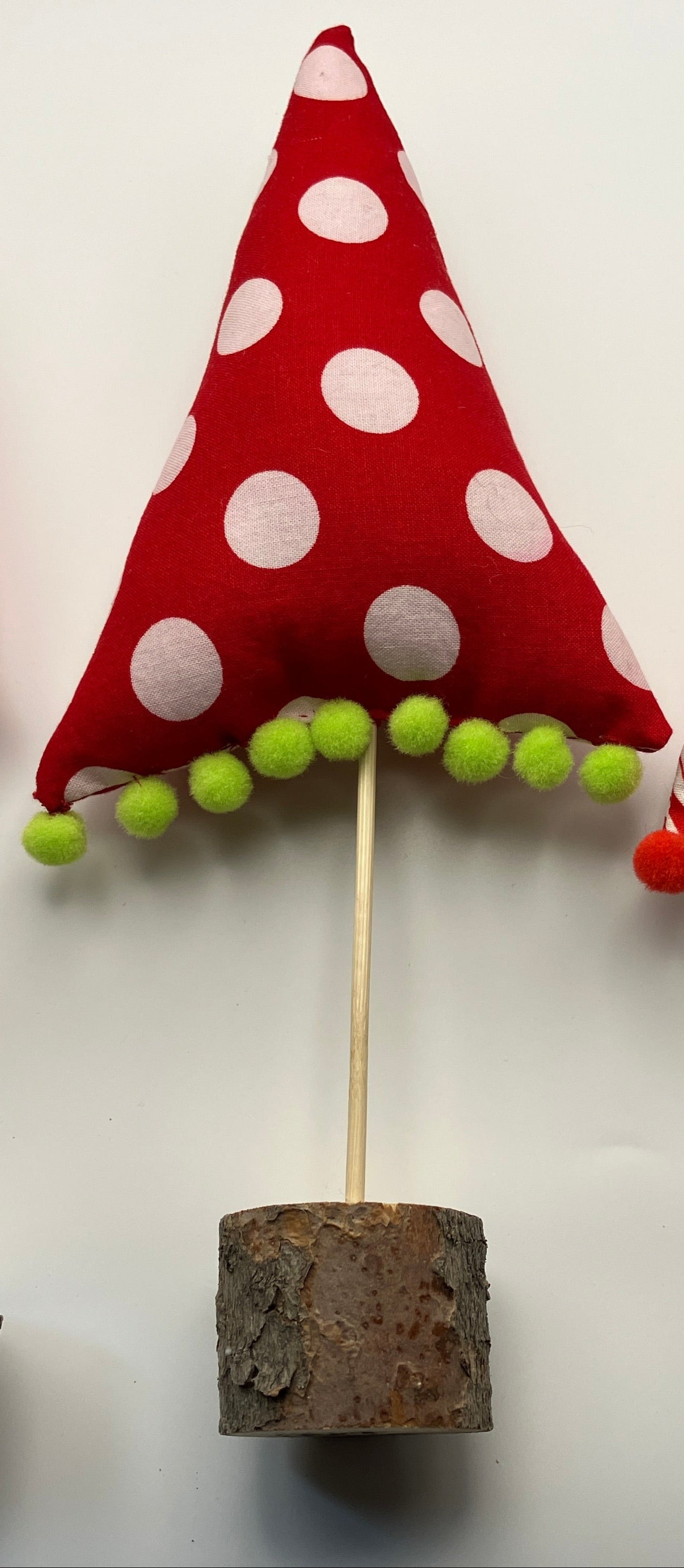 Red and white holiday tree with green pompoms
