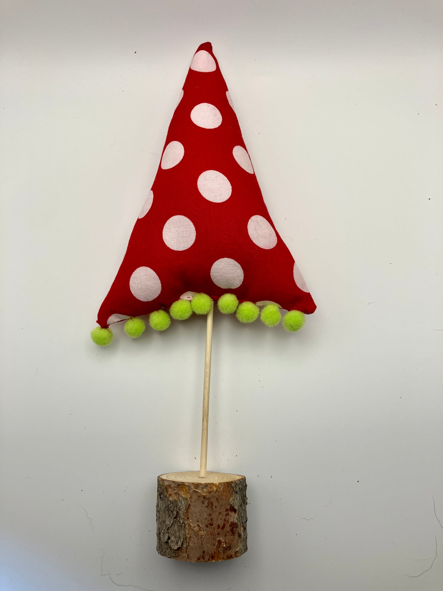 Red and white holiday tree with green pompoms