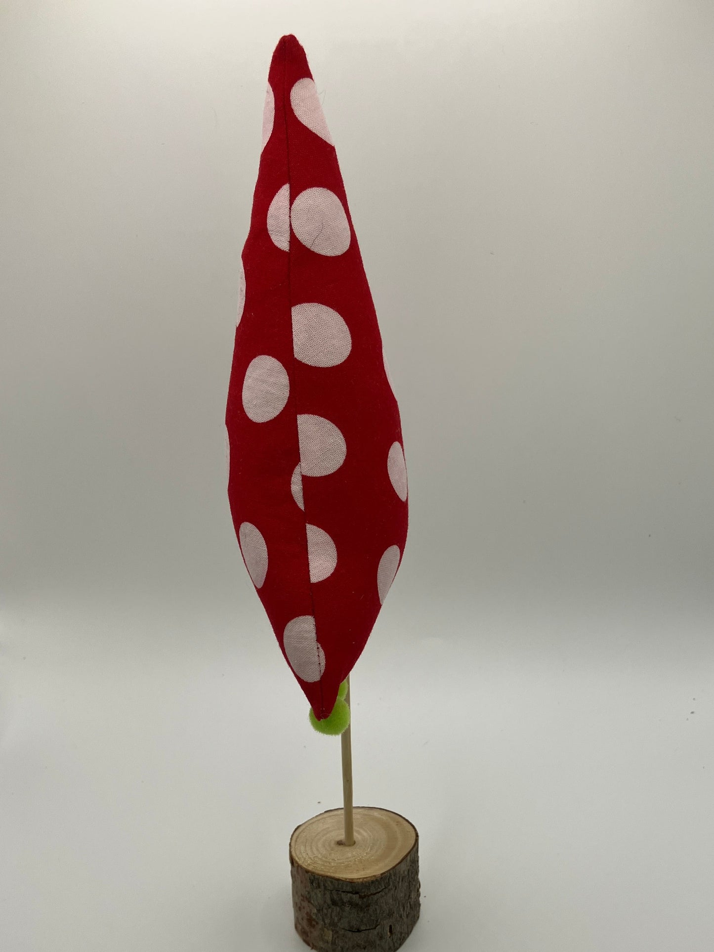 Red and white holiday tree with green pompoms