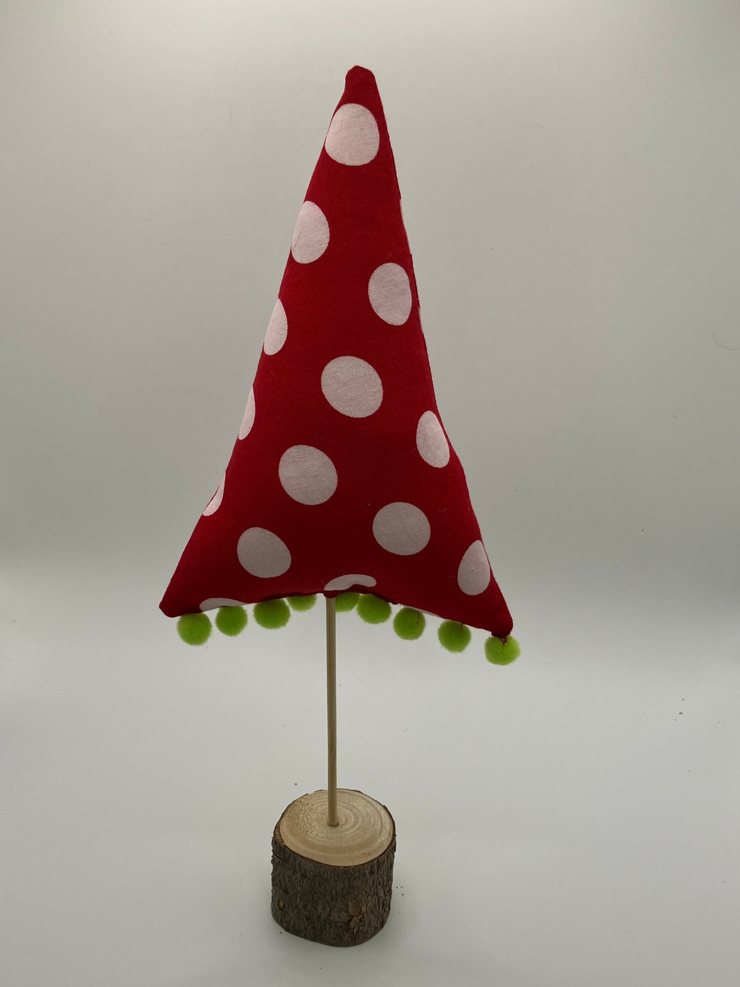 Red and white holiday tree with green pompoms