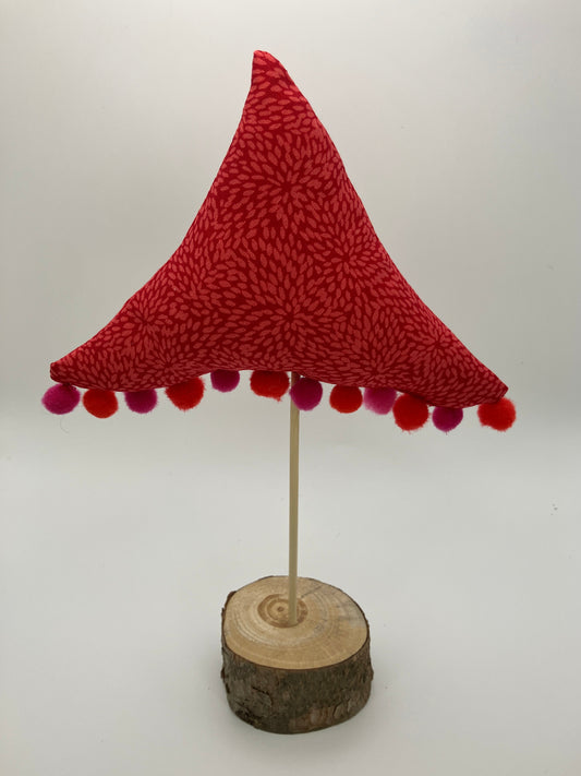 Red pattern fabric tree with pink and red pompoms.